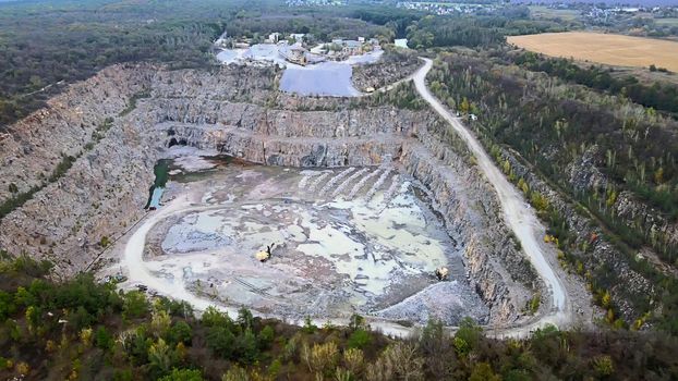 Aerial drone view of career in Europe, crushed stone quarry at summer sunset