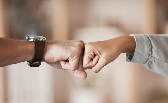Hands, teamwork and fist bump with a business man and woman fist bumping together in their office. Winner, goal and collaboration with a male and female employee celebrating a goal or target at work