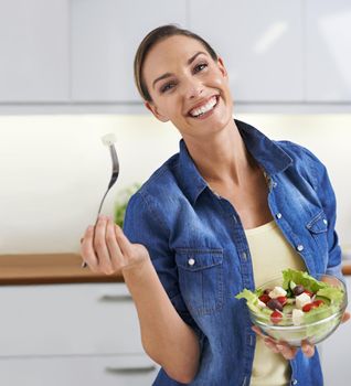 Delicious and healthy. A young woman enjoying a delicious salad.