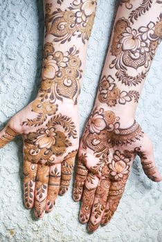 women applying henna on hand
