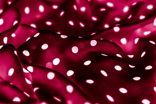 Classic polka dot textile background texture, white dots on red luxury fabric design pattern