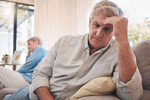 Divorce, fight and problem with senior couple on sofa for conflict, cancer or depression together. Mental health, frustrated and angry with man and woman in retirement with fear, sad and marriage