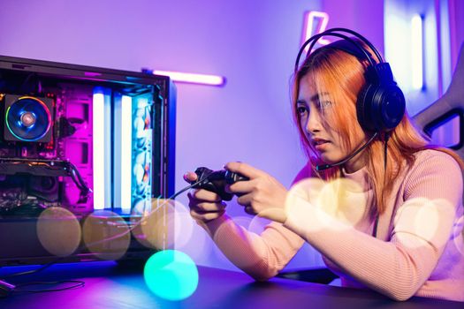 Woman wear gaming headphones playing live stream esports games console