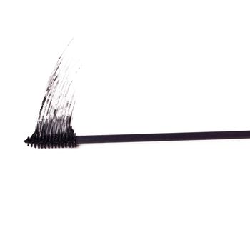 Black is the new black. Studio shot of a mascara brush smearing makeup against a white background.