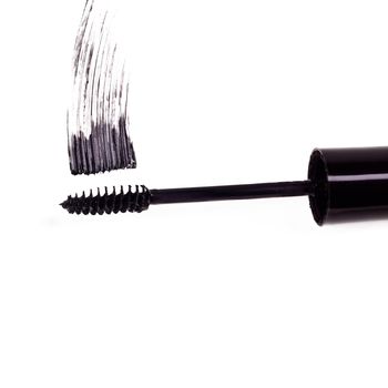 Black is the new black. Studio shot of a mascara brush smearing makeup against a white background.