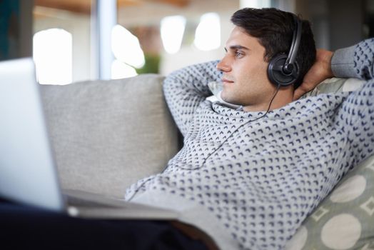 His tranquil gaze. a relaxed young man wearing headphones.