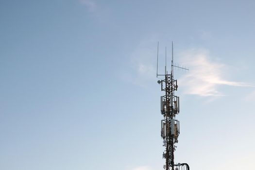 Cellular tower against the blue sky. Modern technologies.