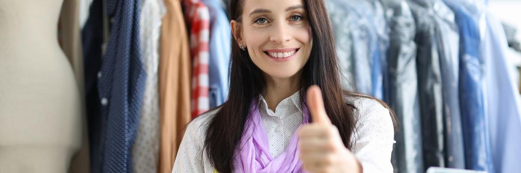 Young beautiful tailor woman showing thumbs up