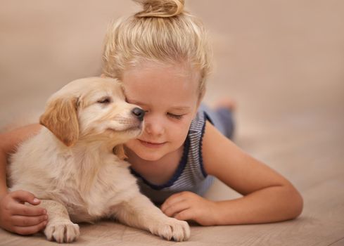 The best friend you can get. An adorable little girl with her puppy at home.
