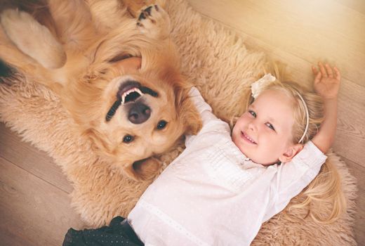 The best friend you can get. An adorable little girl with her dog at home.