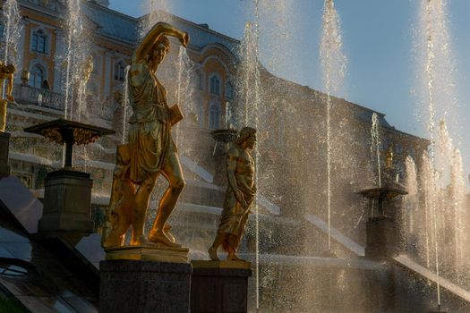 RUSSIA, PETERSBURG - AUG 19, 2022: fountain petersburg palace russia peterhof grand st cascade golden, concept church blue from gold from saint sky, summer cross. Flow sight luxury,