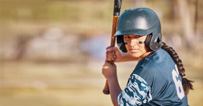Baseball woman, game face and ready to hit ball with bat on a field. Sports player with eye paint, waiting to strike and concentration to win match by competitive female batter focus during training