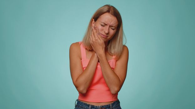 Woman touching cheek suffering from toothache cavities or gingivitis waiting for dentist appointment