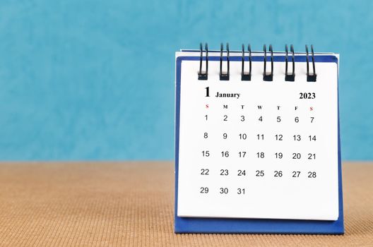 The January 2023 desk calendar on blue color background.