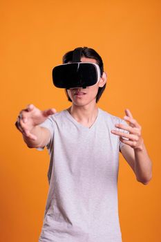 Man in vr headset playing games, enjoying simulation experience