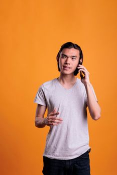Asian man chatting on smartphone, communication