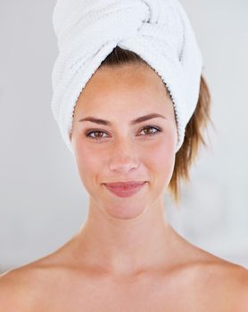 What shall we do first Hair. Head shot of a stunning brunette woman with her hair wrapped up in a towel.