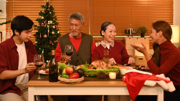 Group of people enjoying Thanksgiving meal in comfortable home. Celebration, holidays and Christmas concept