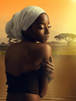 African allure. a beautiful woman standing against the backdrop of an african sunset.
