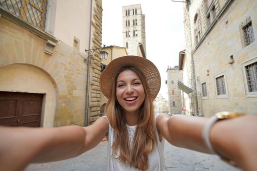 Self portrait of beautiful tourist girl in the historic town of Arezzo, Tuscany, Italy