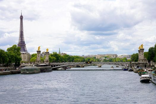 Seine River with Pont Alexandre III Bridge and Eiffel Tower in Paris, France