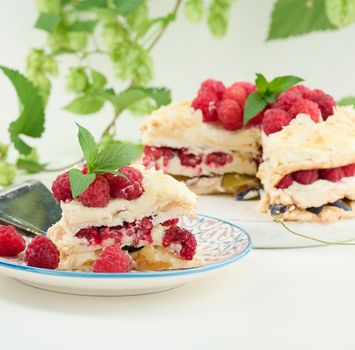 Round meringue pie with fresh raspberries on a white background, Pavlova dessert
