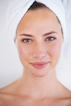 Clean, smooth skin. Head and shoulders view of beautiful woman looking content.