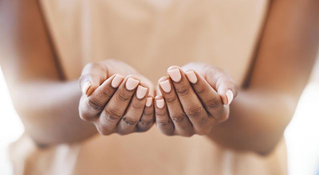 Charity, open hands and a praying woman in a christian worship church for spiritual wellness. Closeup of palms of an african girl in poverty with give and receive gesture at a community support event
