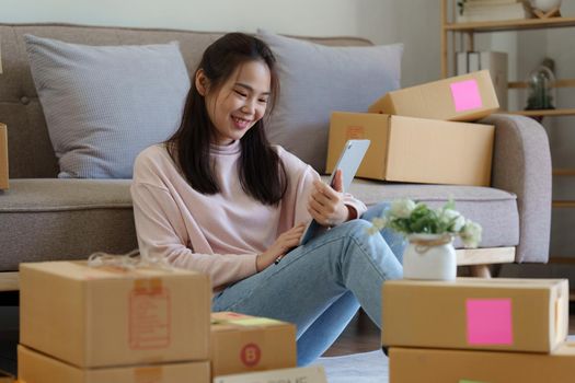 Asian SME business woman working at home office. online shopping concept