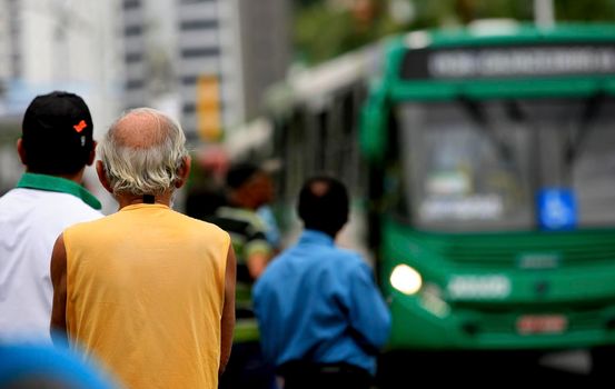 salvador, bahia / brazil - september 22, 2016: Senior citizen is seen waiting for public transportation bus from Salvador city.