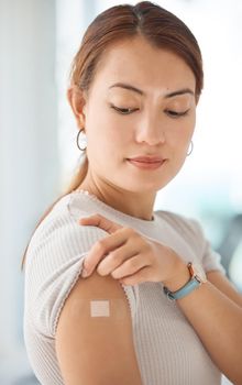 Healthcare, covid and vaccine with woman and bandaid on arm for medical, patient and wellness against virus. Medicine, support and health with girl after vaccination for sick, flu or illness