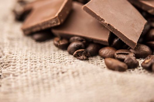 Chocolate and coffee beans on a textile background