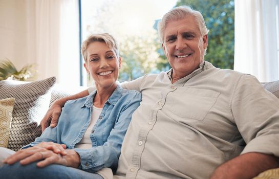 Couple, love and retirement with a senior man and woman sitting together in the living room of their home. Happy, smile and affection with an elderly male and female pensioner in their house to relax