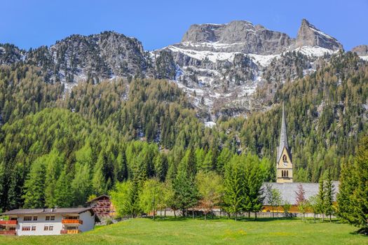 Village near Cortina D Ampezzo and alpine meadows with Dolomites alps, Italy