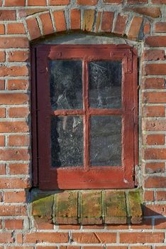 Just a touch of rustic charm. A close-up image of a rustic window frame on a brick house.