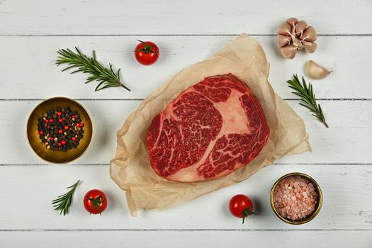 Close up raw beef ribeye steak on paper