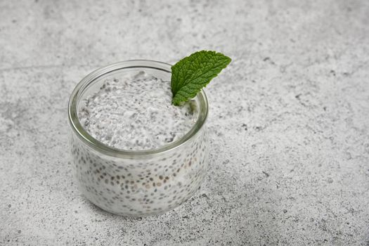 Jar of chia seeds pudding with coconut milk