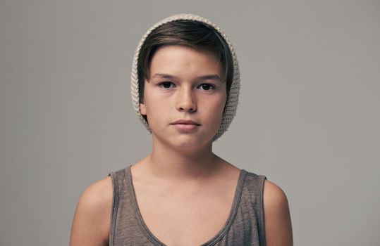 Young and hip. Studio portrait of a stylishly dressed young boy wearing a woolen hat.