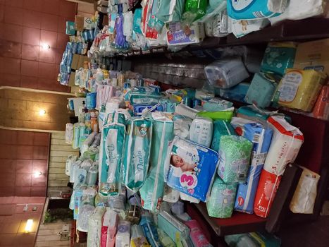 Pile of diapers and other diapers in the warehouse of the volunteer center. Dnipro, Ukraine - 04.22.2022