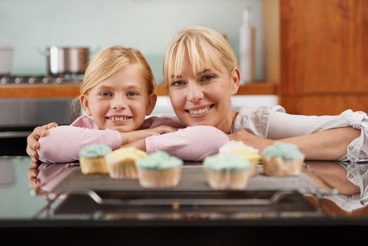 Baked to perfection. an attractive young woman baking with her adorable daughter.