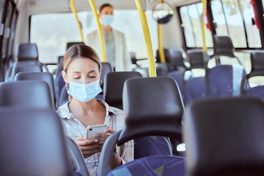 Covid, travel and phone social media with mask for illness prevention on public bus trip. Safety protocol girl face protection online with mobile app for transport leisure entertainment.