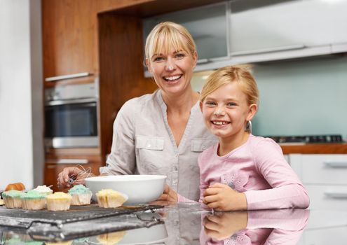 Mommy and me baking time. an attractive young woman baking with her adorable daughter.
