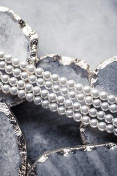 Pearl jewellery on marble, luxury background