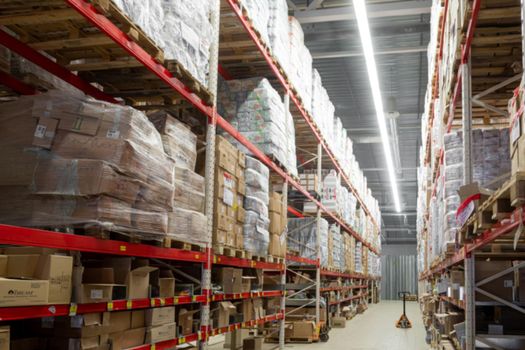 automated warehouse complex with high-bay shelving, blurred photography, defocus