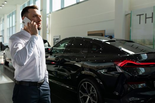 businessman purchasing a new premium car at a car dealership