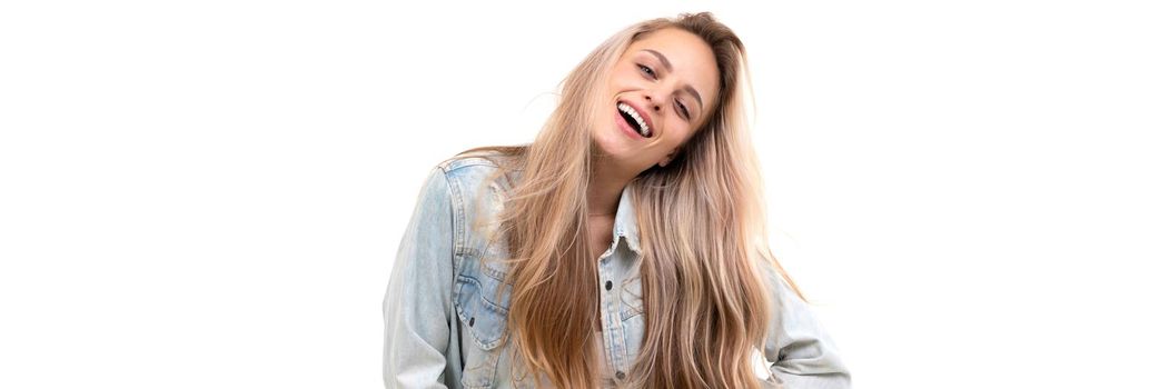 cheerful blonde on a white background in a denim light blue jacket with long hair with a smile on her face