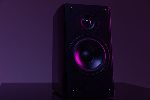 music speaker from home theater on dark background with purple backlight, music industry professionals concept