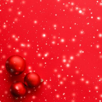 Christmas baubles on red background with snow glitter, luxury winter holiday card