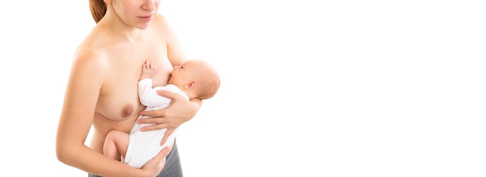 newborn takes mother's breast drinking milk on a white background