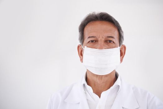 Prepped for dental surgery. Studio portrait of a dentist wearing a mask.
